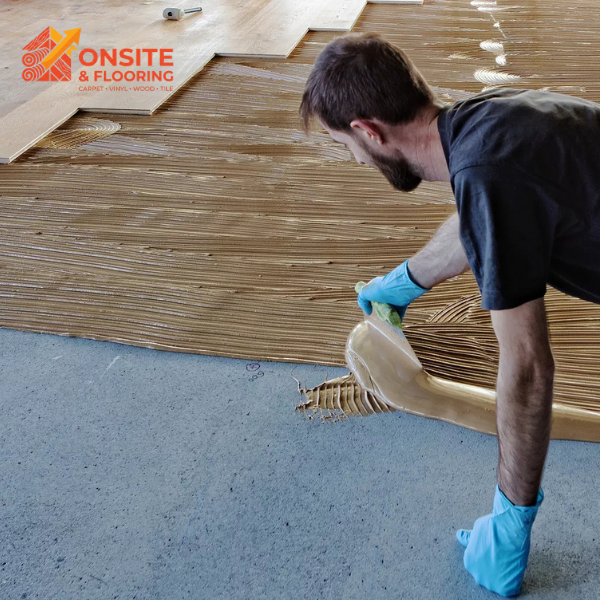 Master installer leveling and laying tile adhesive